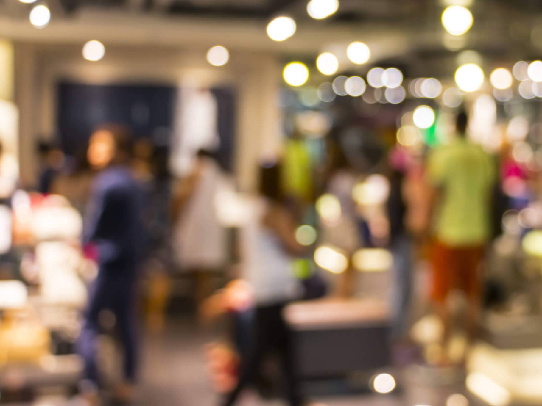 hotel gift voucher sales showing a busy blurred hotel reception scene.