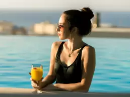 girl holding a drink in a pool