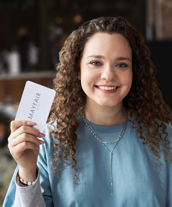 Woman holding Mayfair gift card