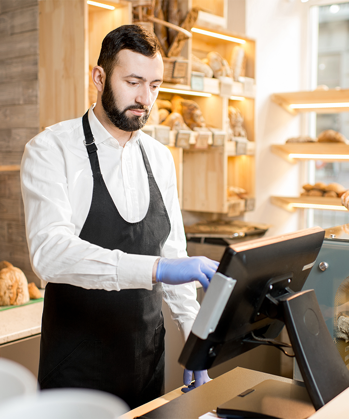 Staff member processing a transaction through their restaurant POS system