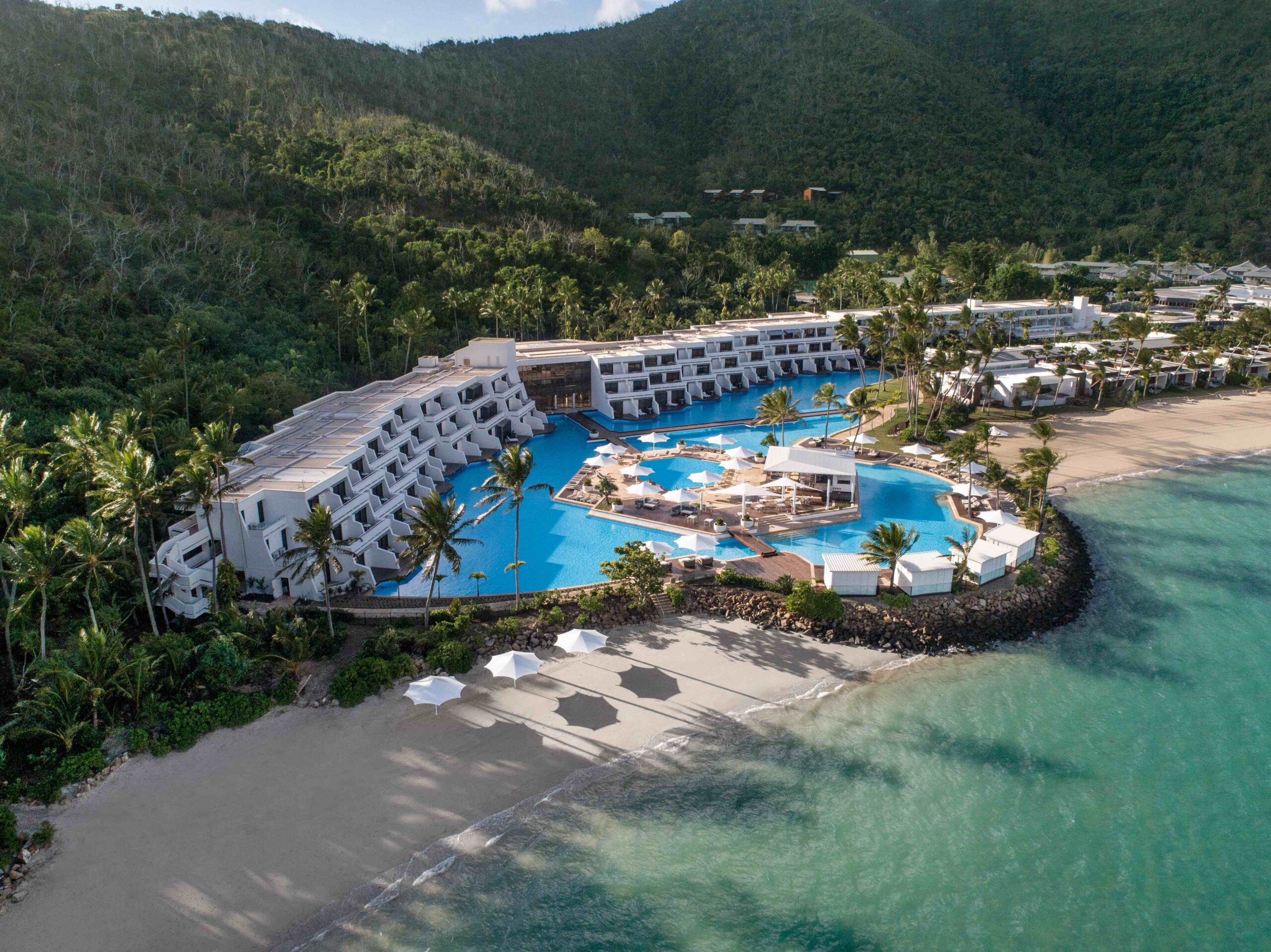 Aerial view of InterContinental Hayman Great Barrier Reef featuring its beachfront pool on Hayman Island